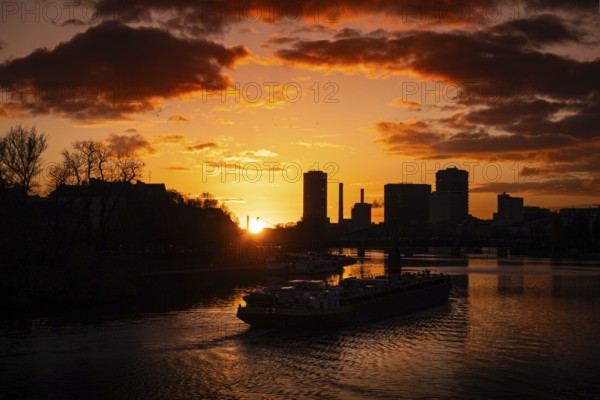 The sun sets behind the Main and Frankfurt Westhafen Tower, Alte Brücke, Frankfurt am Main, Hesse,