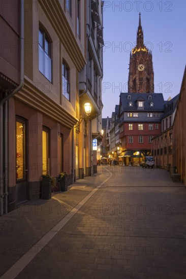 The lights in the shops of Frankfurt's New Old Town and the top of St. Bartholomew's Cathedral glow