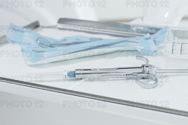 A carpal syringe, reusable, for use in dentistry, for the administration of anesthetic, lies on the