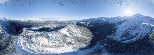 Wonderful winter landscape with Zugspitze, blue sky and snow, mountains and mountain valley, aerial