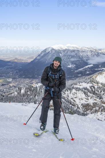 Happy ski tourer climbing to Längenfelderkopf, in winter, Wetterstein Mountains,