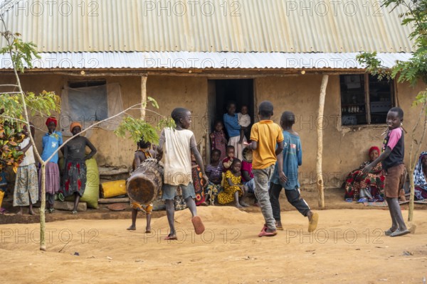 Residents in the main house of a village, children with drums, in a Sadaani village, Tanga,