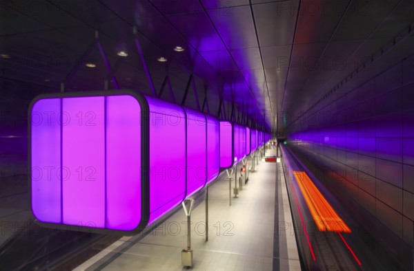 HafenCity University underground station, illuminated in color, magenta, underground train, motion