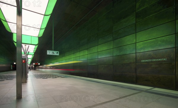 HafenCity University underground station, illuminated in color, green, underground train, motion