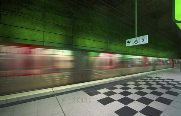 HafenCity University underground station, illuminated in color, green, underground train, movement
