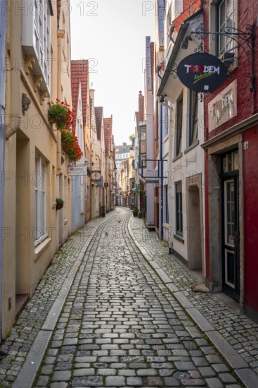 Colourful houses with shops in a small alley, picturesque district with nice little houses,
