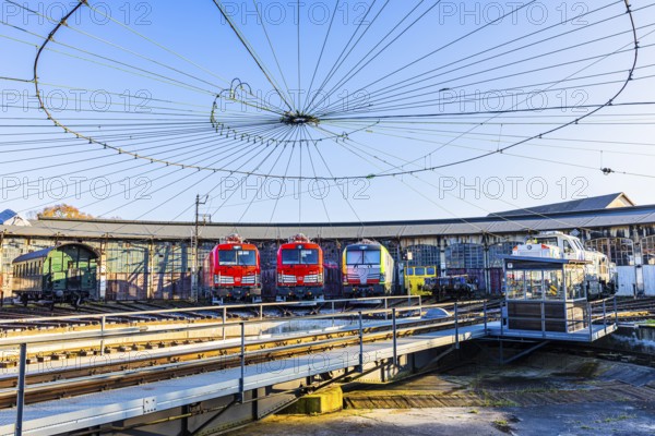 Turntable and overhead line spider, behind it modern locomotives of the Austrian Federal Railways,
