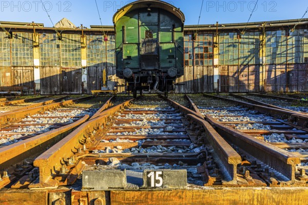 Historic railroad car parked in front of the old engine shed, Augsburg railway park, administrative