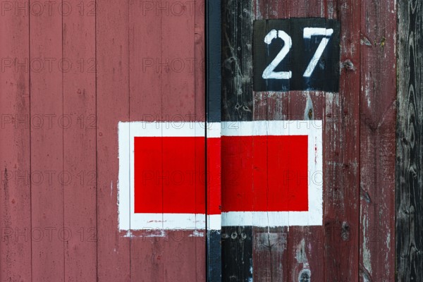 Protection signal with red and white paint at entrance gate no. 27 to the old engine shed, Augsburg