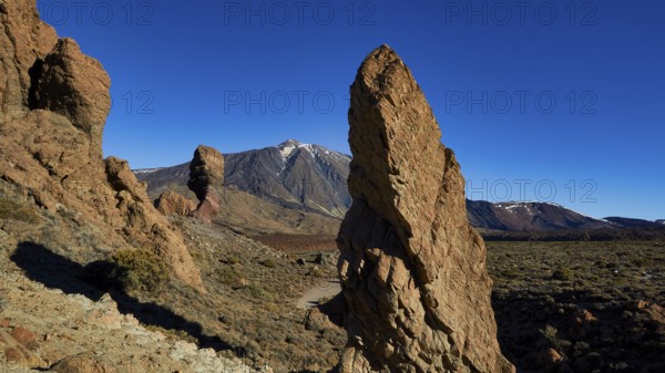 Volcanic rock formations in dry landscape with blue sky, UNESCO World Heritage Site, Teide National