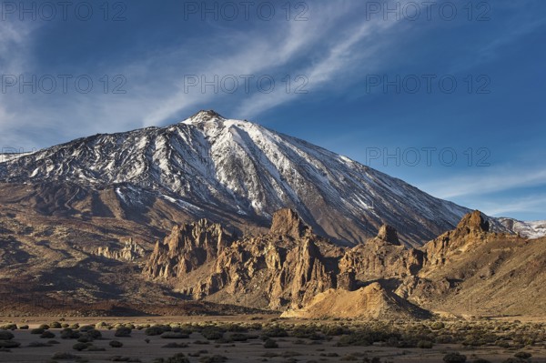 Snow-capped Teide, large mountain with illuminated shadows and deep blue sky, UNESCO World Heritage