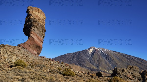 Distinctive rocky outcrop in front of volcano in barren surroundings, UNESCO World Heritage Site,