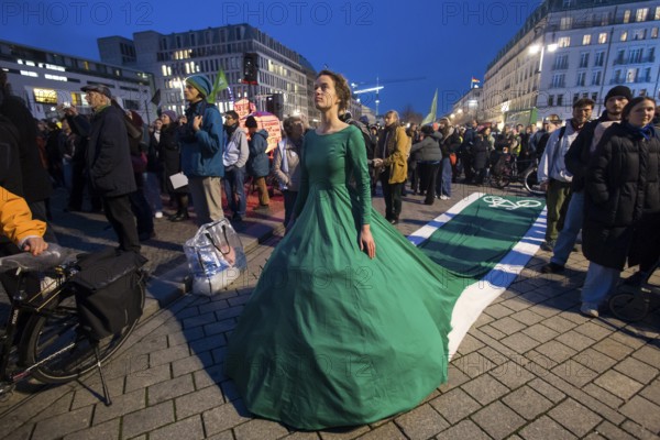 Athena Macke (costume designer) wears a dress with a long train in the shape of a bike path (bike