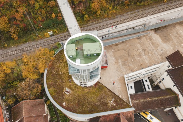 Tower with balcony and parking area, surrounded by autumn leaves and railroad tracks, Hermann