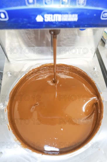 Close-up of liquid chocolate flowing from a machine, Christmas baking, Haselstaller Hof, Wildberg,