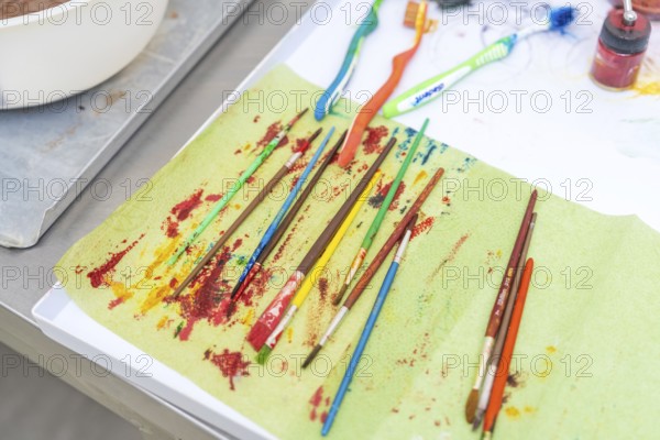 Colourful brushes and toothbrushes on a creatively designed table, Christmas baking, Haselstaller
