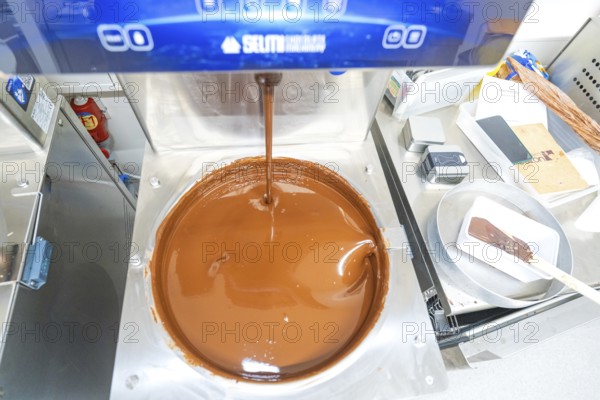 Chocolate machine with liquid chocolate in a commercial kitchen, Christmas baking, Haselstaller