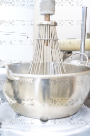 A large industrial metal mixing machine in a production kitchen, Weihnachtsbacken, Haselstaller