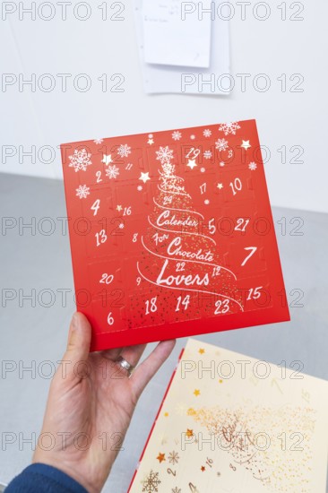 Red advent calendar for chocolate lovers with printed snowflakes, Christmas baking, Haselstaller