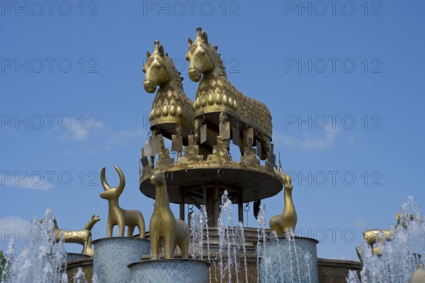 An impressive fountain with golden horse and ram statues under clear skies, Colchis Fountain, David