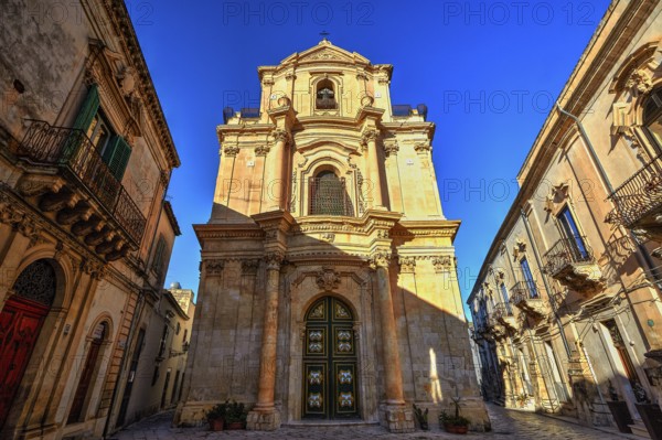 Scigli, magnificent baroque church under clear blue sky, typical of historical architecture,