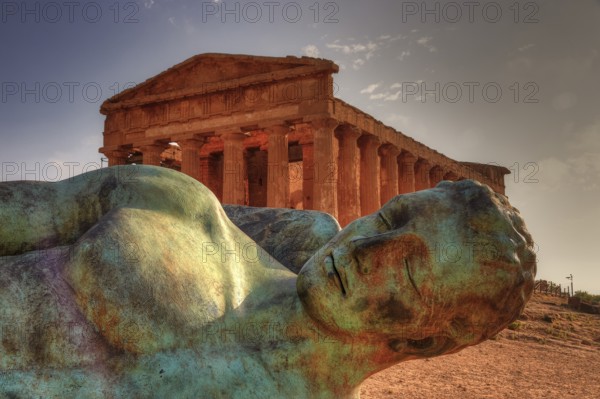 Bronze statue of fallen Icarus, Temple of Concordia, bronze statue in front of an ancient temple in