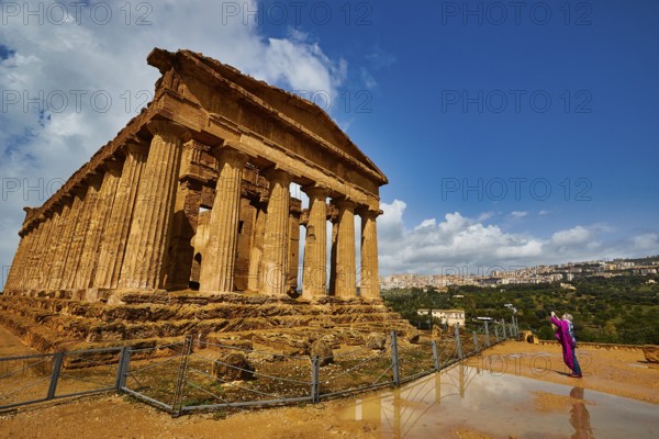 Temple of Concordia, large ancient temple with Doric columns and a person in the foreground, Valley