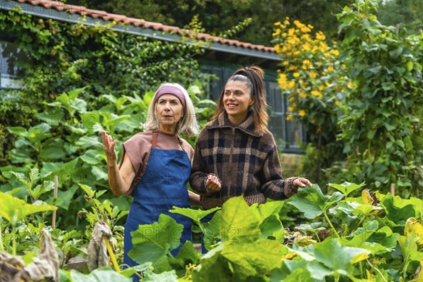 Mother and adult daughter enjoying time together in a lush green garden, the older woman teaching