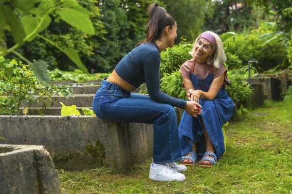 Two smiling women, a mother and daughter, enjoying a conversation outdoors, strengthening their