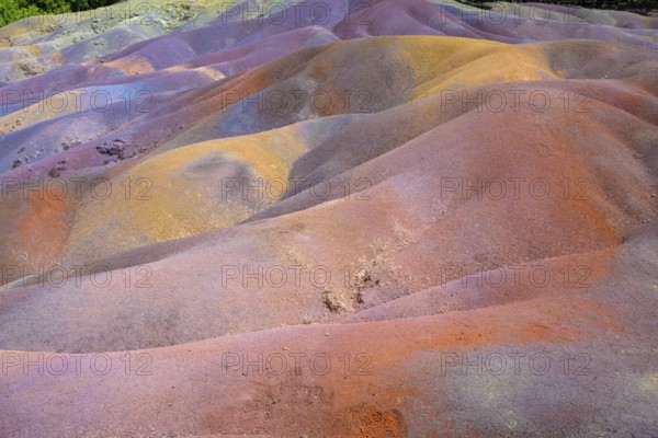 Bright multi-colored mounds of sand that form a wavy pattern. Africa, East Africa, Mauritius,