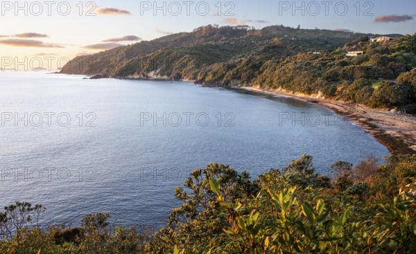 Landscape and sea in New Zealand. View of Te Karo Bay (Sailors Grave) in the morning at sunrise. Te