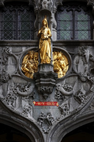 Golden figures on the richly decorated façade of the St. Ivo Chapel at the Basilica of the Holy