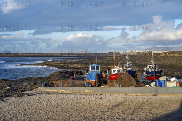 Colourful fishing boats at the port of La Santa, coast with volcanic rocks, La Santa, Lanzarote,