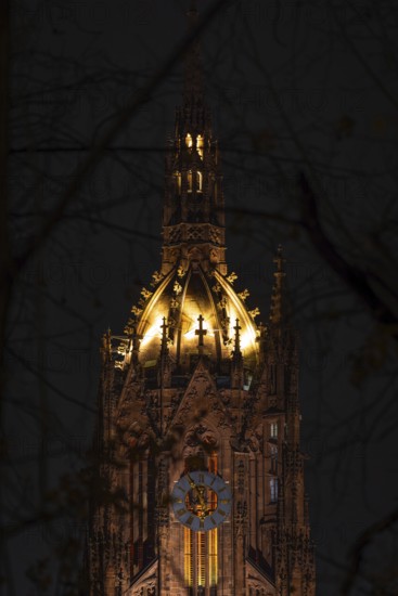 The top of St. Bartholomew's Cathedral in Frankfurt am Main glows like a crown in the evening,