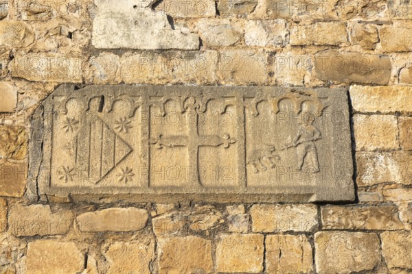 Religious stonework imagery on church wall, Echo or Hecho, Valle de Hecho, Pyrenees Mountains,