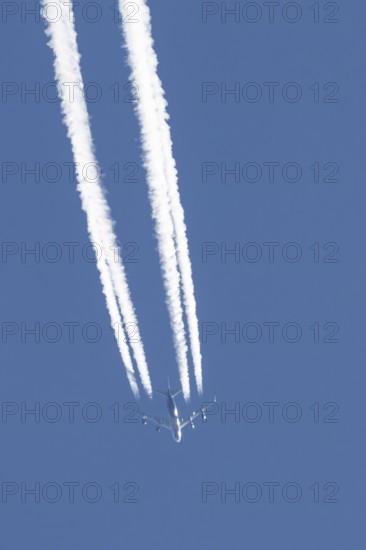 Boeing 747 jumbo jet cargo aircraft of Atlas air airlines flying in a blue sky with contrails or
