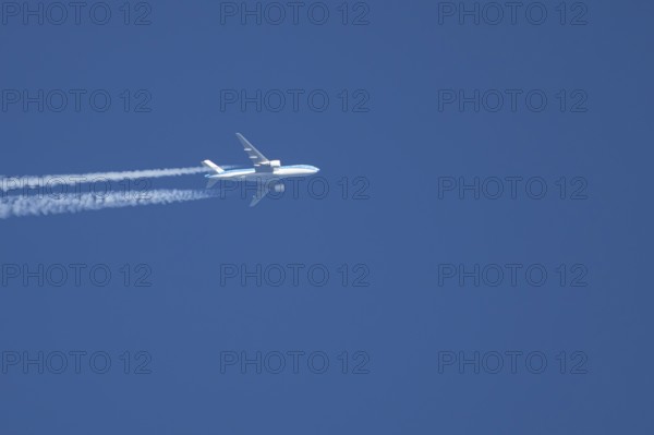 Airbus jet passenger aircraft of Royal Dutch KLM airlines flying in a blue sky with contrails or