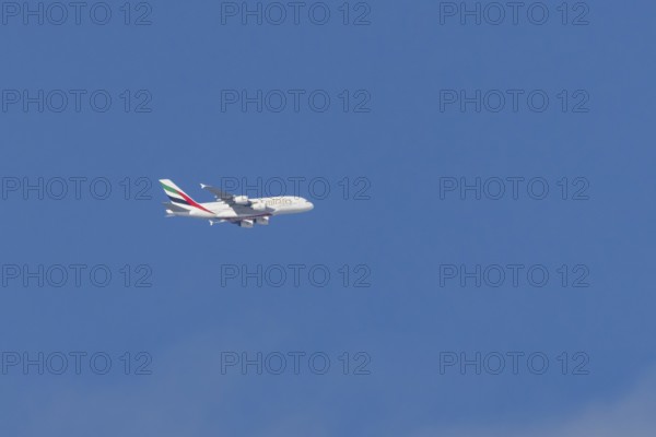 Airbus A380 jet passenger aircraft of Emirates airlines flying in a blue sky, England, United