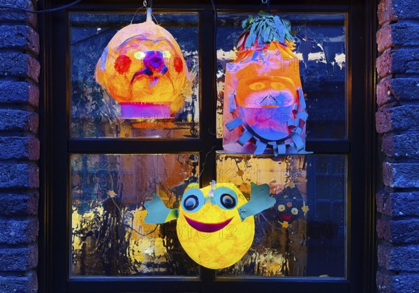 Homemade lanterns for the Martin procession in front of a window in the evening, Old Town, Kempen,