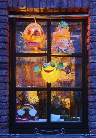 Homemade lanterns for the Martin procession in front of a window in the evening, Old Town, Kempen,