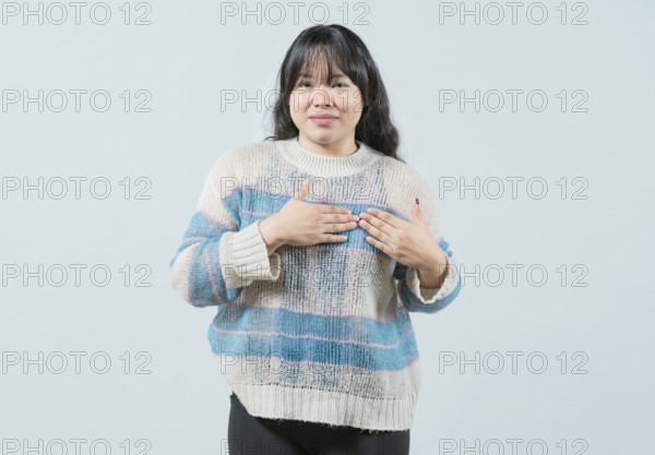 Asian girl gesturing GRATITUDE in sign language. Young woman making gesture GRATEFUL in sign