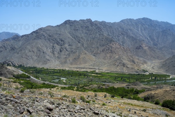 A vast valley with green vegetation surrounded by dry mountains, views of Iran, Aras River near