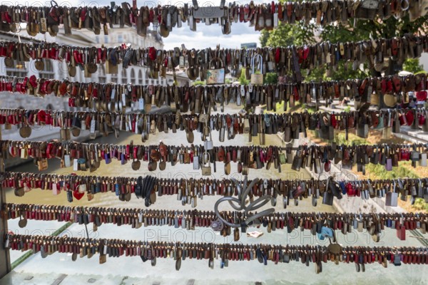 Love locks hang in several rows on the railing of the Mesarski Most (butcher's bridge) over the