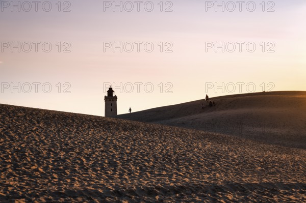 Rubjerg Knude lighthouse, walkers on hiking dune, evening mood in summer, Løkken, Lokken,