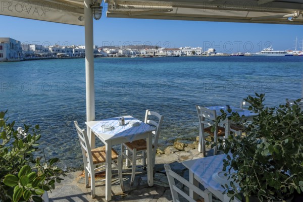Mykonos, Cyclades, Greece - Small picturesque tavern right on the waterfront, on the harbor in the