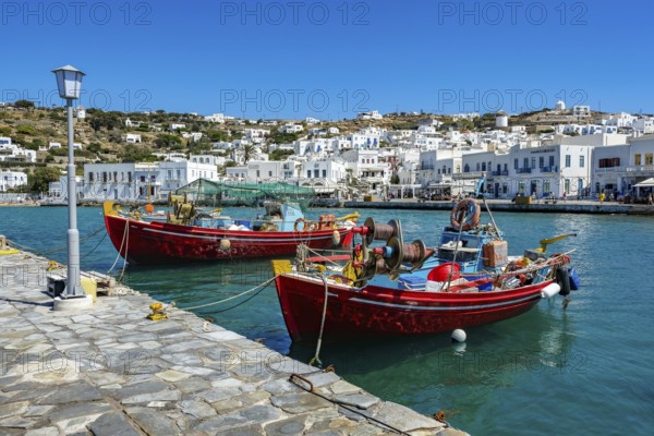 Mykonos, Cyclades, Greece - Colourful fishing boats are moored on the quay in the old port of