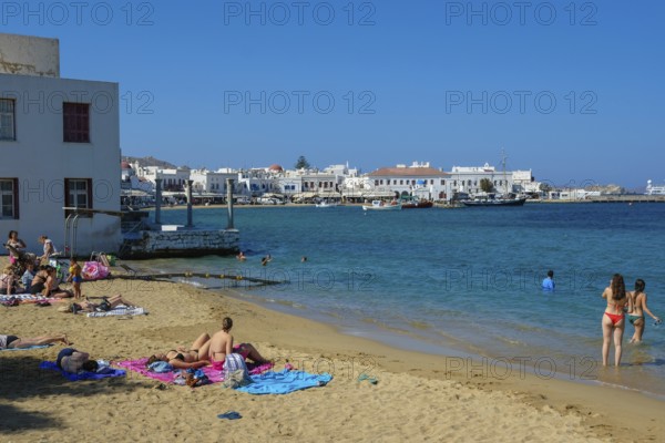 Mykonos, Cyclades, Greece - Tourists and locals like to bathe on the small town beach Paralia Chora