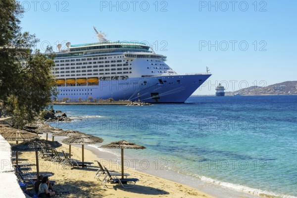 Mykonos, Cyclades, Greece - Voyager of the Seas cruise ship is located in Mykonos Harbour Bay.