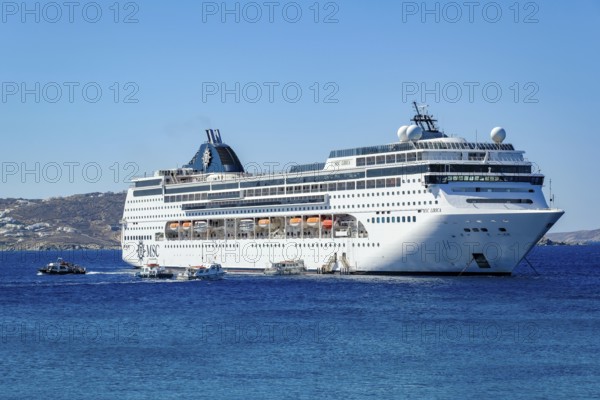 Mykonos, Cyclades, Greece - Cruise ship MSC Lirica is located in Mykonos Harbour Bay. Cruise ships