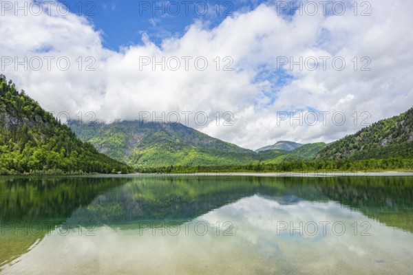 Landscape of Lake Offensee after rain when the sun comes through the clouds in spring,
